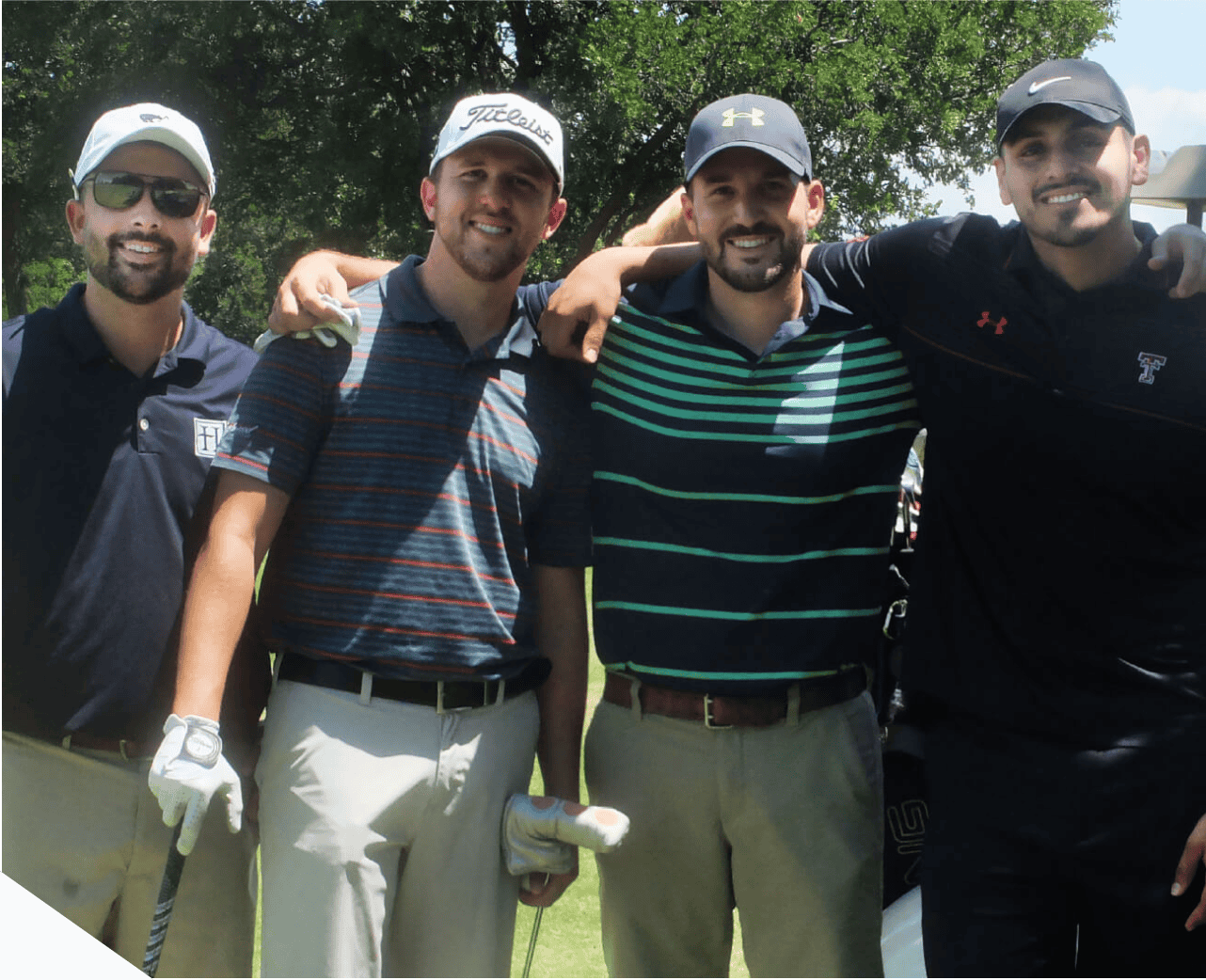A group of men posing for a photo at a driving range.