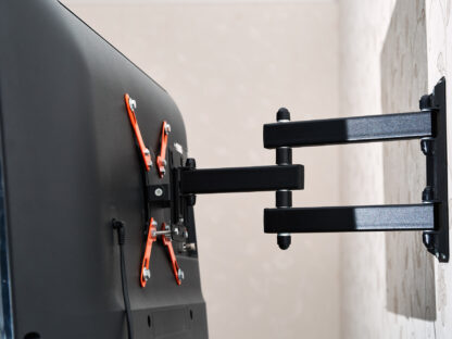 Back view of a wall-mounted flat-screen TV with an adjustable black and orange bracket.
