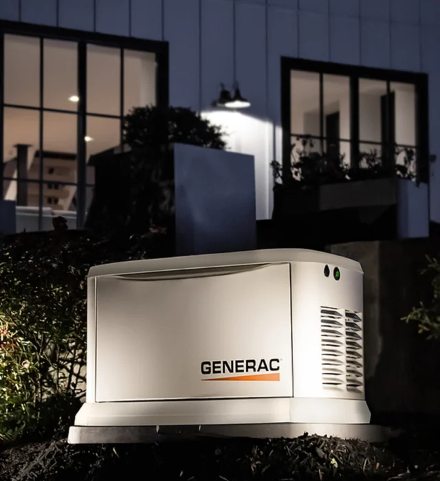 Generac generator installation with outdoor lighting illuminating the standby generator in DFW, Texas