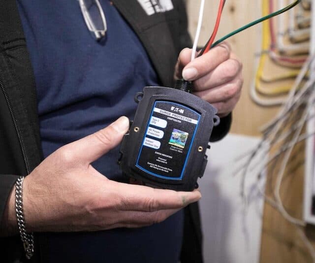 a texas electrician installing a whole house surge protector