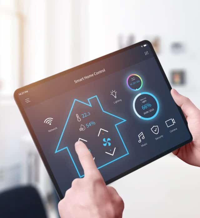 Man using a smart home app on a tablet to control electronics throughout his house in texas